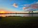 Scenic sunset view of lake and homes from a grassy backyard at 23503 Waverly Cir, Venice, FL 34293