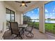 Lanai with table and chairs, offering a lake view at 23503 Waverly Cir, Venice, FL 34293