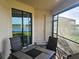 Screened lanai with table and chairs and lake view at 23503 Waverly Cir, Venice, FL 34293
