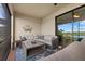 Covered lanai with wicker furniture and lake view at 23503 Waverly Cir, Venice, FL 34293