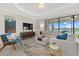 Spacious living room with large sectional sofa and lake view at 23503 Waverly Cir, Venice, FL 34293