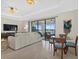 Spacious living room with sectional sofa, large windows and water view at 23503 Waverly Cir, Venice, FL 34293