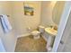 Small powder room with pedestal sink and toilet at 23503 Waverly Cir, Venice, FL 34293