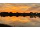 Stunning sunset reflected in calm lake water at 23503 Waverly Cir, Venice, FL 34293
