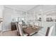 Dining room with modern table and chairs, mirrored accent wall at 31526 Ancient Sage Rd, Wesley Chapel, FL 33545