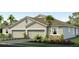 Two-story home with three car garage and landscaped front yard at 31526 Ancient Sage Rd, Wesley Chapel, FL 33545