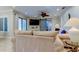 Living room with tiled floors, a ceiling fan, and a barn door at 3540 Indigo Pond Dr # 1, Palm Harbor, FL 34685