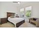 Comfortable bedroom with a large bed, ample natural light, and neutral decor at 4383 Ortona Ln, Wesley Chapel, FL 33543