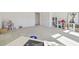 This large bonus room is well lit and features a carpeted floor and various types of storage and play items at 4383 Ortona Ln, Wesley Chapel, FL 33543