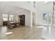 Bright dining area with wood floors, elegant furniture, and natural light from the large windows at 4383 Ortona Ln, Wesley Chapel, FL 33543
