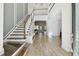 Elegant foyer with staircase, bench, and natural wood floors creating a grand entrance at 4383 Ortona Ln, Wesley Chapel, FL 33543