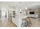 An open-concept gourmet kitchen with an island overlooks the living room at 4383 Ortona Ln, Wesley Chapel, FL 33543