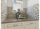 Granite countertop with mosaic tile backsplash hosts the coffee and espresso bar at 4383 Ortona Ln, Wesley Chapel, FL 33543