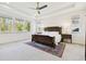Spacious main bedroom with a large bed, carpet flooring, and natural light at 4383 Ortona Ln, Wesley Chapel, FL 33543