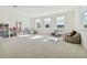 Large playroom with great natural light from multiple windows and neutral decor at 4383 Ortona Ln, Wesley Chapel, FL 33543