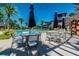 Resort-style pool area with tables, lounge chairs, umbrellas, and waterslide in background at 4383 Ortona Ln, Wesley Chapel, FL 33543
