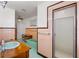 Retro bathroom with a mint green tub and pink tile walls at 5021 24Th S Ave, Gulfport, FL 33707