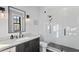 Clean bathroom with white subway tiles, a walk-in shower and dark vanity at 5104 Homer W Ave, Tampa, FL 33629