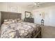 Main bedroom with gray furniture and floral bedding at 5501 80Th N St # 214, St Petersburg, FL 33709