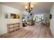 Bright dining room features hardwood floors, chandelier, and living room view at 5501 80Th N St # 214, St Petersburg, FL 33709