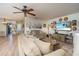 Bright living room featuring comfortable sofas and a large TV at 5501 80Th N St # 214, St Petersburg, FL 33709