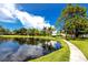 Serene pond with a walking path, offering a peaceful waterfront view at 5501 80Th N St # 214, St Petersburg, FL 33709