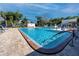 Inviting community pool with lounge chairs at 5501 80Th N St # 214, St Petersburg, FL 33709