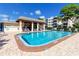 Community pool with a covered patio area and ample seating at 5501 80Th N St # 214, St Petersburg, FL 33709