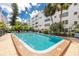 Refreshing community swimming pool with surrounding patio furniture at 5501 80Th N St # 214, St Petersburg, FL 33709