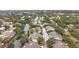 Aerial view of a townhome community with mature trees, a canal and a community pool at 6262 93Rd N Ter # 3904, Pinellas Park, FL 33782
