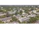 Aerial view of a townhome community with mature trees, a canal and a community pool at 6262 93Rd N Ter # 3904, Pinellas Park, FL 33782