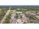 Aerial view of a townhome complex showcasing community street, landscaping, and nearby roads at 6262 93Rd N Ter # 3904, Pinellas Park, FL 33782