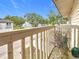Balcony view featuring white railing, lush trees, and neighborhood streets under a clear blue sky at 6262 93Rd N Ter # 3904, Pinellas Park, FL 33782