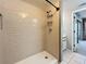Modern bathroom featuring a walk-in shower with bright subway tile, a shower rack, and tiled floors at 6262 93Rd N Ter # 3904, Pinellas Park, FL 33782