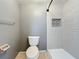 Modern bathroom featuring a walk-in shower with bright subway tile, a toilet, and neutral-toned walls at 6262 93Rd N Ter # 3904, Pinellas Park, FL 33782