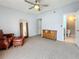 Spacious bedroom with carpeted floors, a vintage mirror and a seating area, leading into an ensuite bathroom at 6262 93Rd N Ter # 3904, Pinellas Park, FL 33782