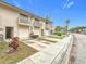 Exterior view of townhome featuring two-story building with balconies and individual garage and driveway at 6262 93Rd N Ter # 3904, Pinellas Park, FL 33782