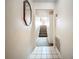 Hallway with tiled floor, a mirror, and view of carpeted stairs leading to upper level at 6262 93Rd N Ter # 3904, Pinellas Park, FL 33782