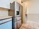 Stainless steel refrigerator next to stairs leading to the open living space above at 6262 93Rd N Ter # 3904, Pinellas Park, FL 33782