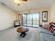 Living room with ceiling fan, sliding glass doors to patio, and comfortable seating area at 6262 93Rd N Ter # 3904, Pinellas Park, FL 33782