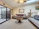 Inviting living room boasts vaulted ceiling, skylights, comfortable furniture, and access to the patio at 6262 93Rd N Ter # 3904, Pinellas Park, FL 33782