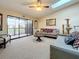Bright living room with skylights, vaulted ceilings, and access to outdoor balcony at 6262 93Rd N Ter # 3904, Pinellas Park, FL 33782