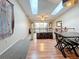 Bright living room with vaulted ceilings and skylights, featuring a dining area and sliding glass doors to a balcony at 6262 93Rd N Ter # 3904, Pinellas Park, FL 33782