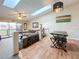 Spacious living room with skylights and ceiling fan featuring a dining area, and access to the outdoor patio at 6262 93Rd N Ter # 3904, Pinellas Park, FL 33782