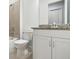Neutral bathroom with granite counters, white vanity, tiled shower and bathtub at 9132 Bernini Pl, Sarasota, FL 34240
