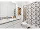 Bathroom featuring granite counters, vanity and shower with patterned shower curtain at 9132 Bernini Pl, Sarasota, FL 34240