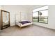Spacious bedroom with a canopy bed, a full-length mirror, and a scenic lake view at 9132 Bernini Pl, Sarasota, FL 34240
