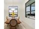 Bright dining room with wooden table, large windows, and lake view at 9132 Bernini Pl, Sarasota, FL 34240