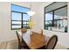 Well-lit dining room with a wooden table set offering scenic views of the surrounding landscape at 9132 Bernini Pl, Sarasota, FL 34240