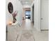 Bright home foyer featuring neutral tones, tile floors, and an open view to the lake at 9132 Bernini Pl, Sarasota, FL 34240